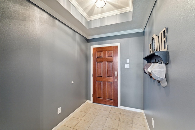 doorway to outside with a tray ceiling, light tile patterned floors, and crown molding