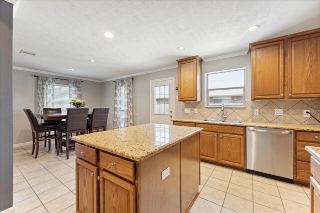 kitchen featuring sink, light tile patterned floors, dishwasher, a center island, and light stone counters