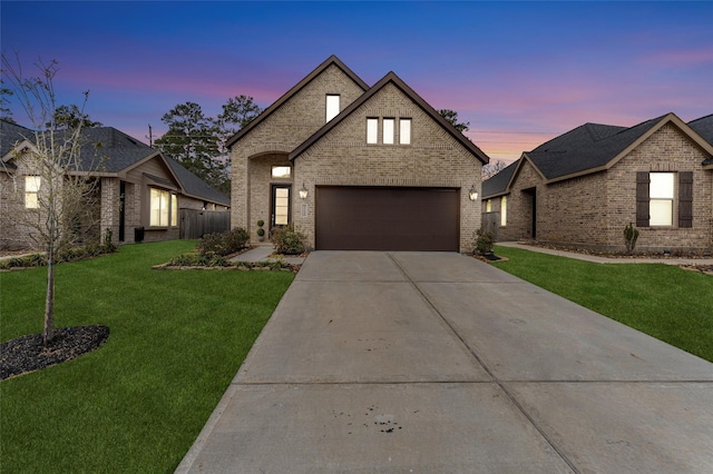 view of front facade with concrete driveway, brick siding, and a front lawn