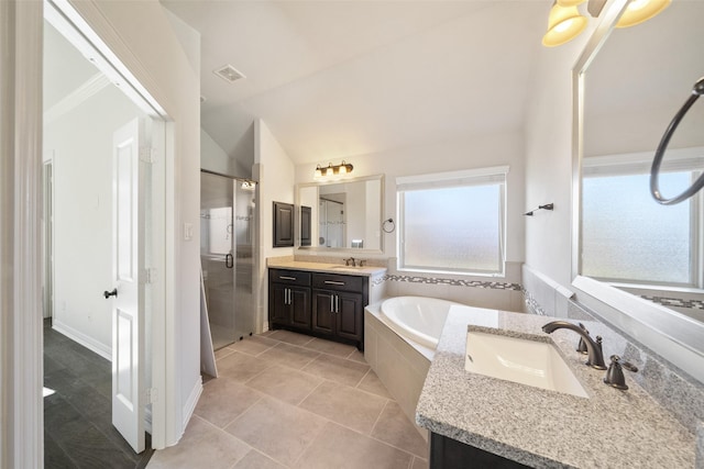 bathroom with tile patterned floors, vanity, plus walk in shower, and vaulted ceiling