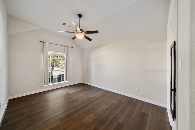 empty room featuring lofted ceiling, dark wood-type flooring, and ceiling fan