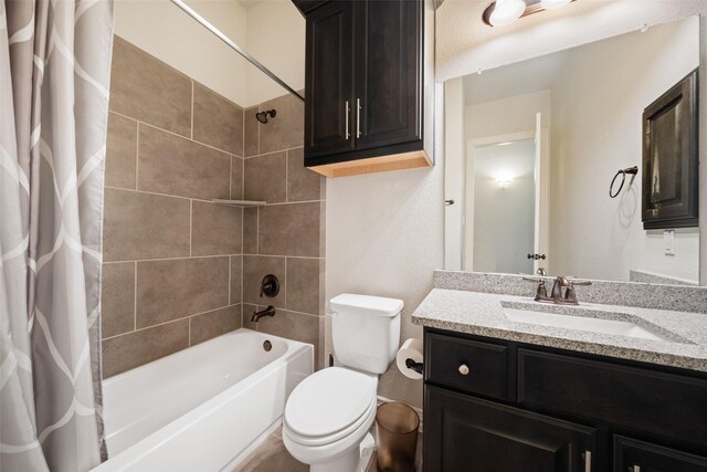 full bathroom with shower / bath combination with curtain, vanity, and toilet