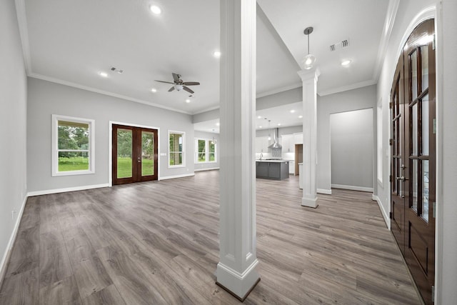 entrance foyer with a healthy amount of sunlight, ornate columns, visible vents, and french doors