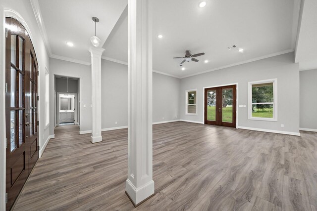 entryway with french doors, crown molding, dark wood finished floors, ornate columns, and baseboards