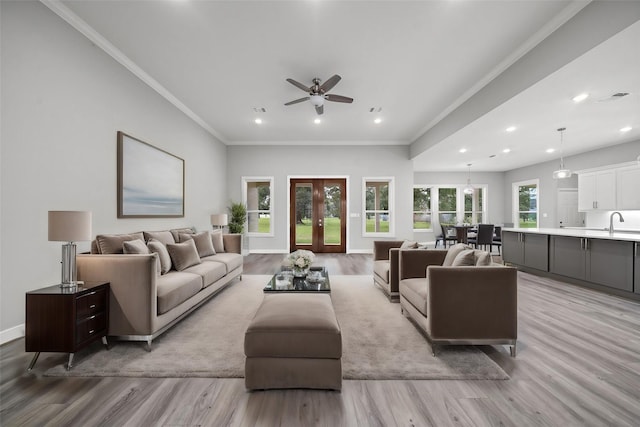 living room featuring light wood-style floors, recessed lighting, ornamental molding, and french doors