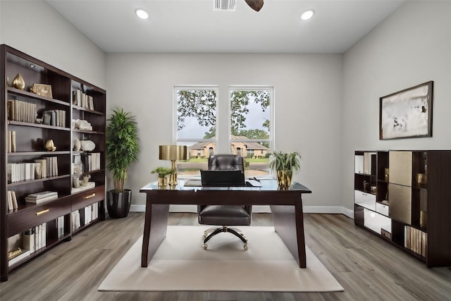 office featuring light wood-style flooring, baseboards, and recessed lighting