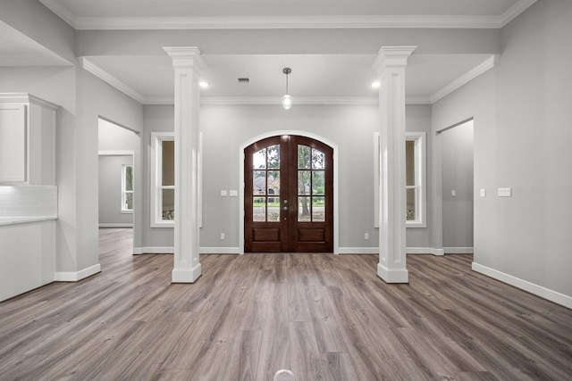 entryway with french doors, light wood-type flooring, and decorative columns