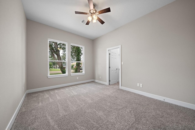 unfurnished room with baseboards, visible vents, ceiling fan, and light colored carpet