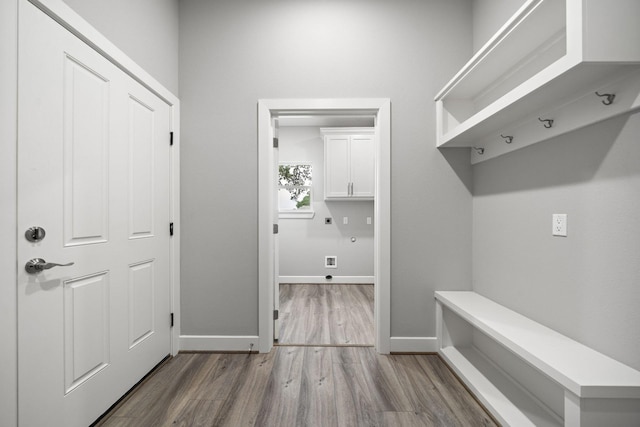 mudroom featuring wood finished floors and baseboards