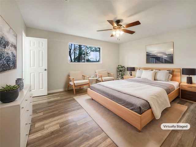 bedroom with wood-type flooring and ceiling fan