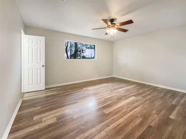 unfurnished room featuring ceiling fan and dark hardwood / wood-style floors