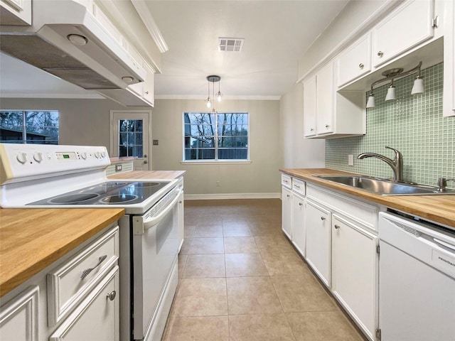 kitchen featuring white appliances, decorative light fixtures, exhaust hood, and white cabinets