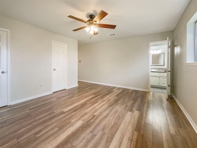 empty room featuring hardwood / wood-style flooring and ceiling fan