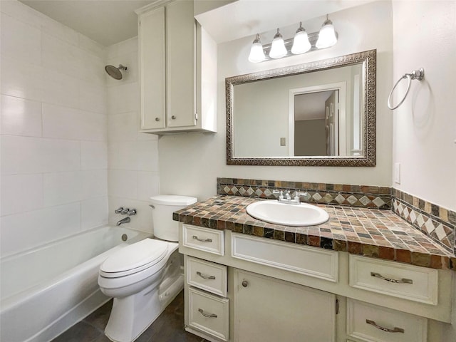 full bathroom with vanity, tiled shower / bath, and toilet