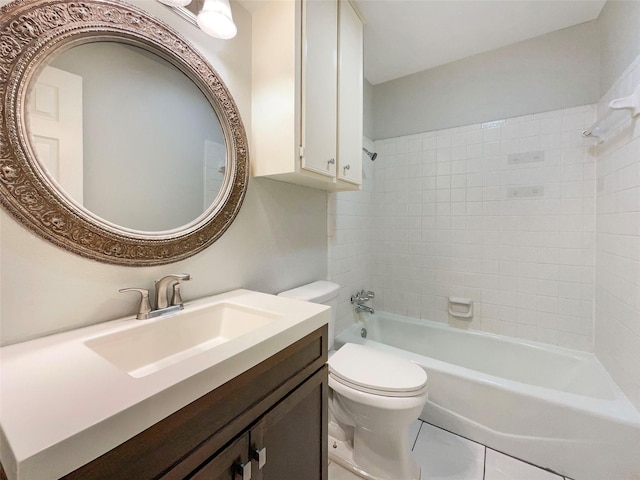 full bathroom featuring tiled shower / bath, vanity, toilet, and tile patterned floors