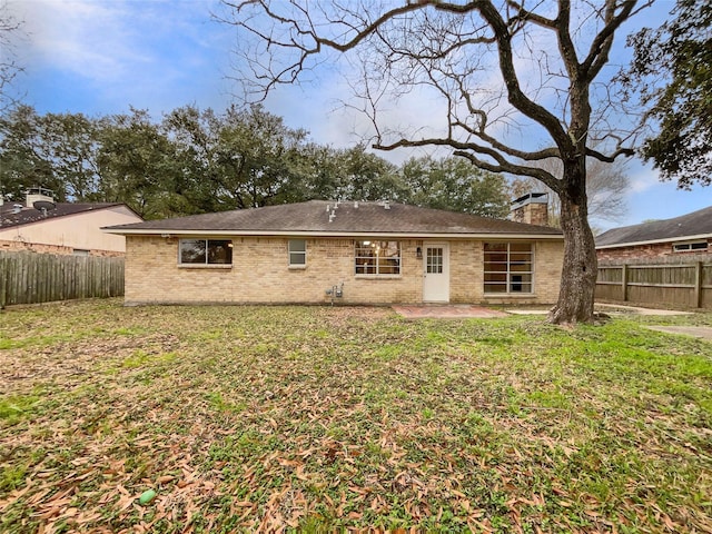 back of property with a lawn