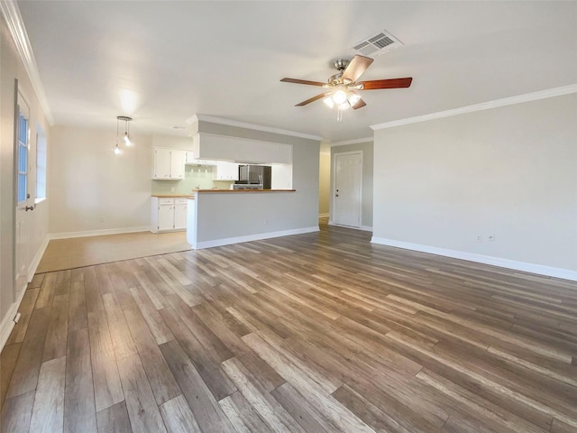 unfurnished living room featuring ornamental molding, dark wood-type flooring, and ceiling fan