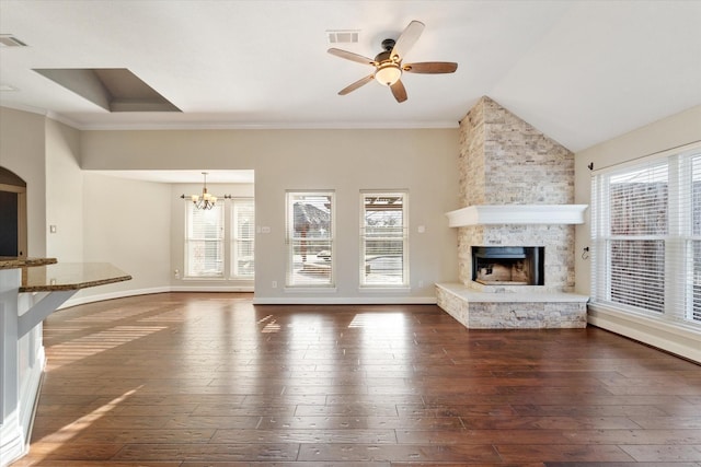 unfurnished living room with ceiling fan with notable chandelier, dark wood-type flooring, a fireplace, visible vents, and baseboards