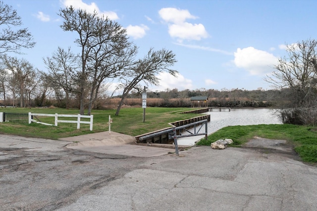 exterior space with a water view and a lawn