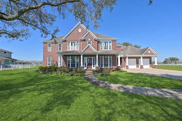 view of front of property featuring a garage, brick siding, fence, driveway, and a front lawn