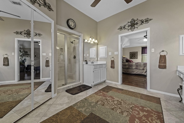 bathroom featuring ceiling fan, vanity, an enclosed shower, and tile patterned floors