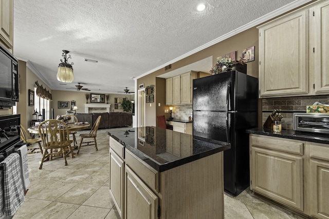 kitchen with a center island, ornamental molding, pendant lighting, ceiling fan, and black appliances