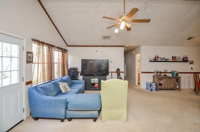 living room with vaulted ceiling, carpet, ceiling fan, and a textured ceiling