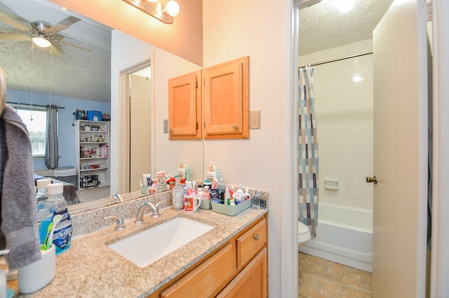 full bathroom with tile patterned floors, toilet, a textured ceiling, vanity, and shower / bathtub combination with curtain