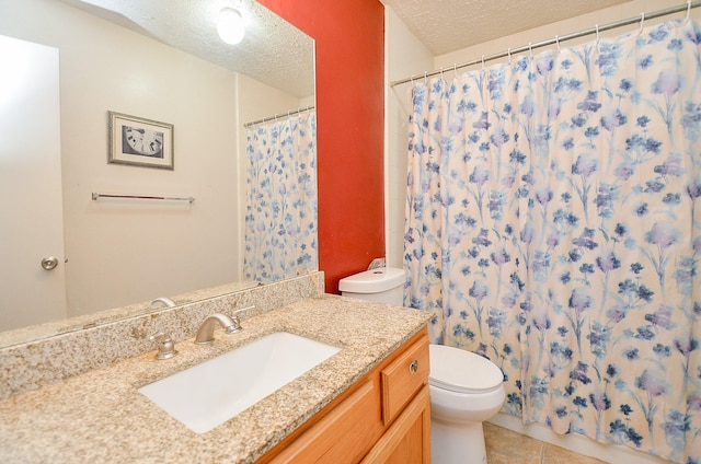 bathroom featuring tile patterned flooring, vanity, a textured ceiling, and toilet