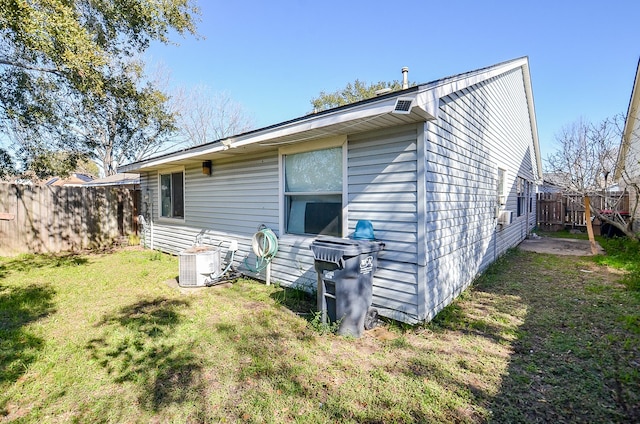 back of property featuring a lawn