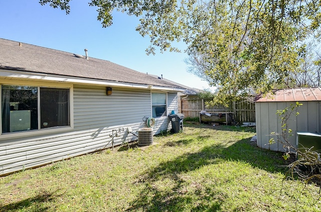 view of yard featuring central air condition unit and a shed