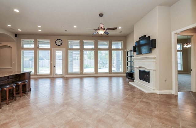 living room featuring light tile patterned floors and ceiling fan