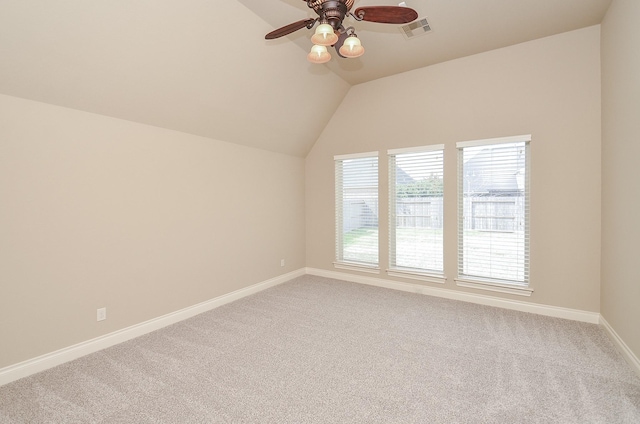 carpeted spare room featuring ceiling fan and lofted ceiling