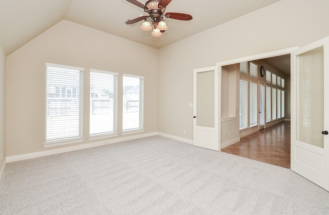 unfurnished room featuring french doors, ceiling fan, lofted ceiling, and carpet