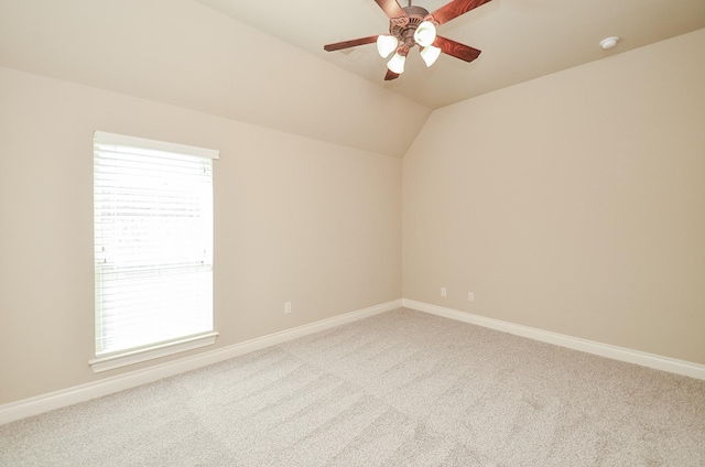 carpeted spare room with ceiling fan, lofted ceiling, and a wealth of natural light