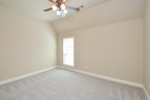 unfurnished room featuring vaulted ceiling, ceiling fan, and carpet floors