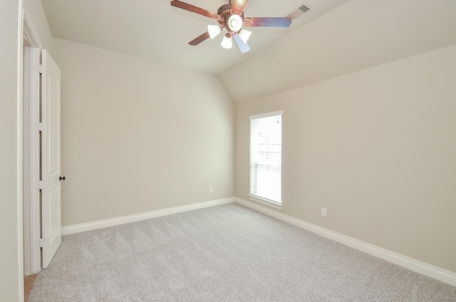 interior space featuring vaulted ceiling, light colored carpet, and ceiling fan