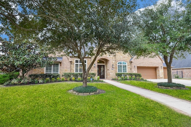 view of front of house with a garage and a front yard