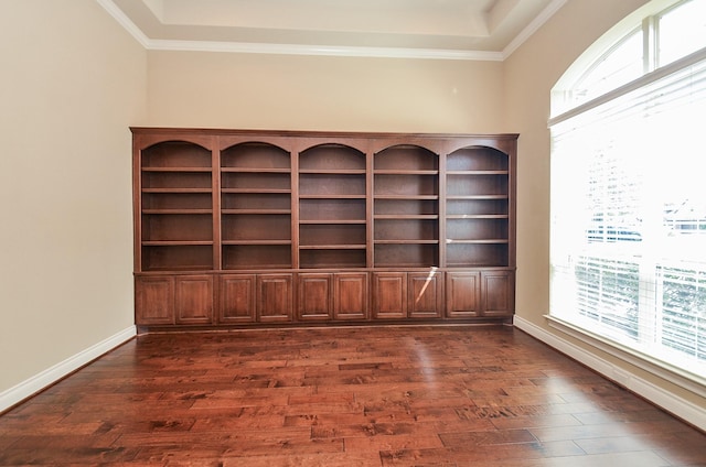 empty room featuring ornamental molding, dark hardwood / wood-style floors, and a wealth of natural light