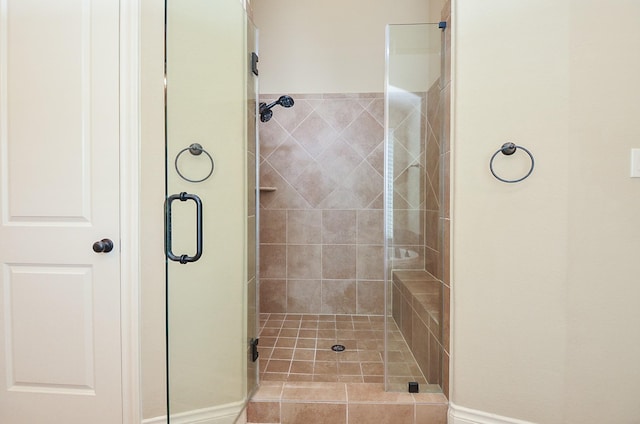 bathroom featuring a shower with door