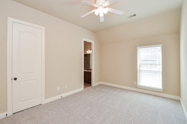 unfurnished room with lofted ceiling, light colored carpet, and ceiling fan