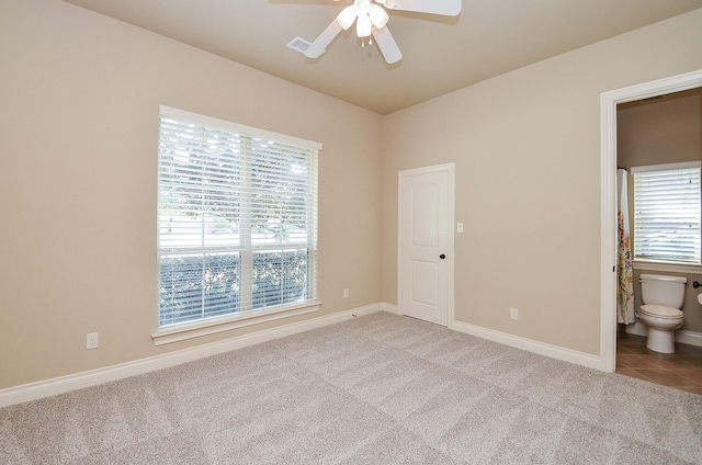 carpeted spare room with ceiling fan