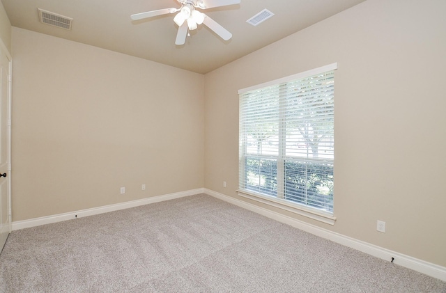 unfurnished room featuring light colored carpet and ceiling fan