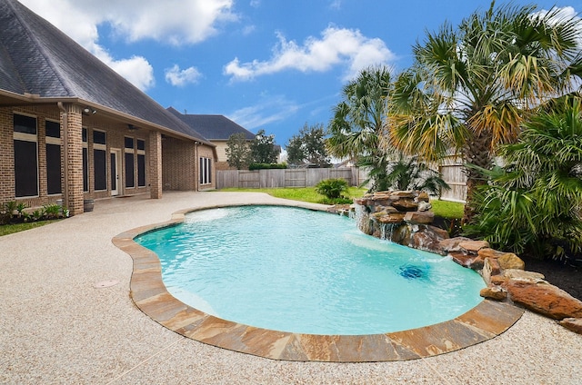 view of pool with pool water feature and a patio area