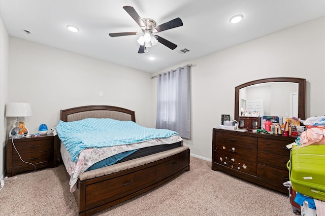 bedroom featuring light colored carpet and ceiling fan