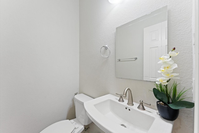 bathroom with toilet and sink