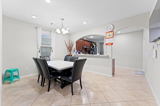 tiled dining space featuring a notable chandelier