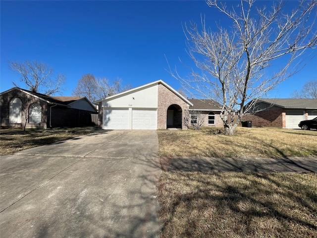 ranch-style house with a garage and a front yard