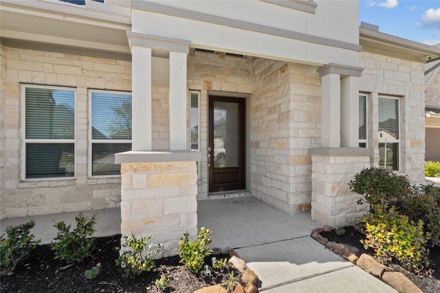 property entrance with stone siding