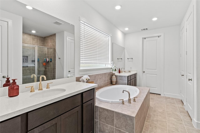 bathroom with a sink, visible vents, a bath, tile patterned floors, and a stall shower